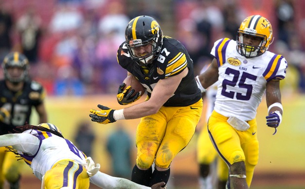 Iowa Hawkeyes tight end Jake Duzey (87) slips past LSU Tigers safety Craig Loston (6) in his way to a 35-yard catch and run during the second half of the Outback Bowl Jan. 1, 2014 in Tampa, Fla.  (Brian Ray/hawkeyesports.com)