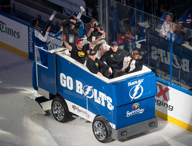 Iowa Hawkeyes tight end Ray Hamilton (82), defensive back B.J. Lowery (19), tight end Henry Krieger Coble (80), and fullback Adam Cox (38) ride a zamboni around the rink during a team outing to a Tampa Bay Lighting hockey game Sunday, Dec. 29, 2013 in Tampa. (Darren Miller/hawkeyesports.com)