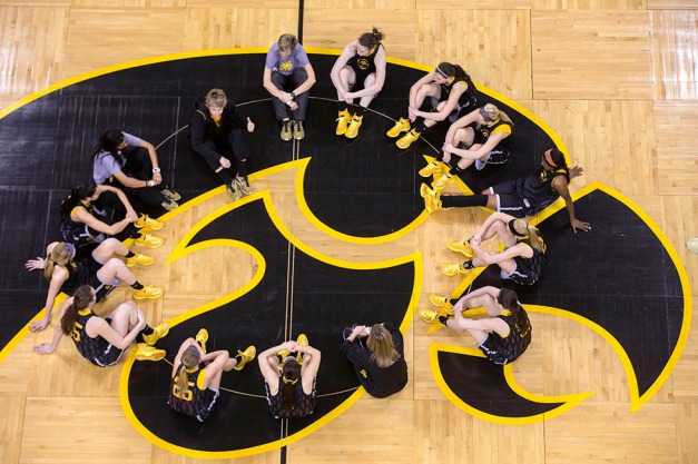 The Iowa Hawkeyes gather at center court before their game against Louisville in the second round of the 2014 NCAA Women's Basketball Tournament  Tuesday, March 25, 2014 at Carver-Hawkeye Arena in Iowa City.  (Brian Ray/hawkeyesports.com)