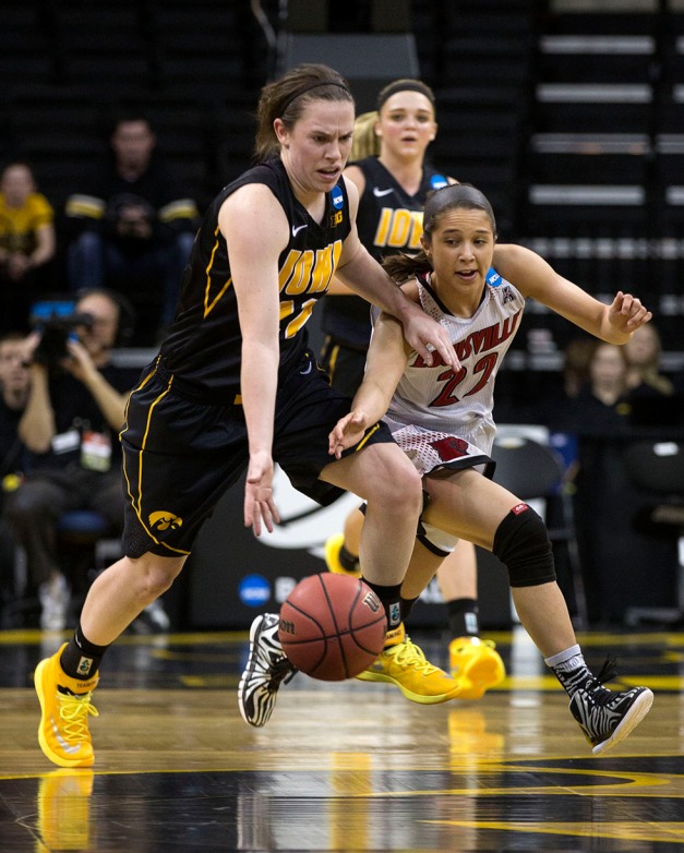 Iowa Hawkeyes guard Samantha Logic (22) steals the ball from Louisville Cardinals guard Jude Schimmel (22) during the first half of their game in the second round of the 2014 NCAA Women's Basketball Tournament  Tuesday, March 25, 2014 at Carver-Hawkeye Arena in Iowa City.  (Brian Ray/hawkeyesports.com)