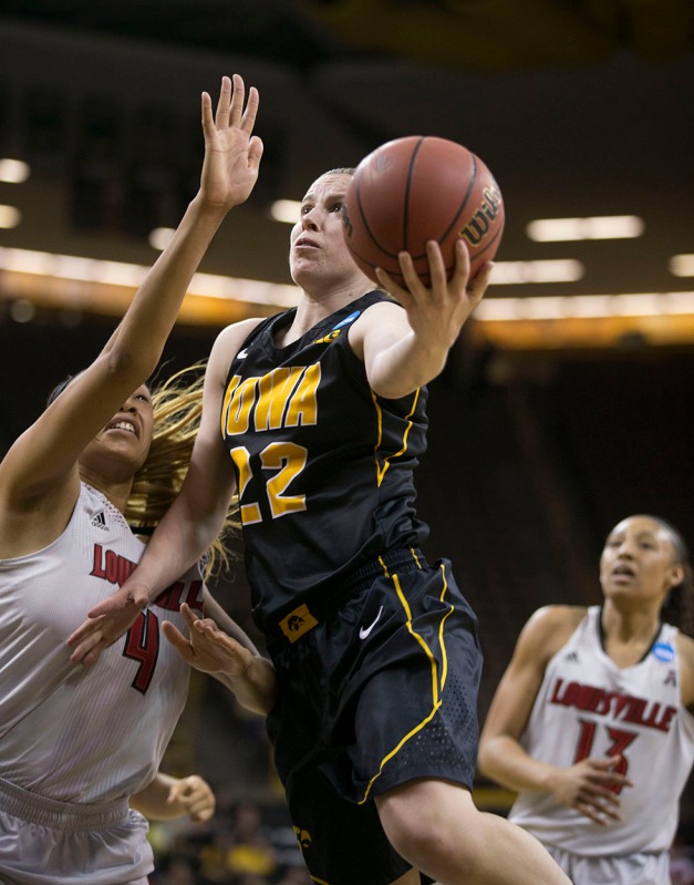 Iowa Hawkeyes guard Samantha Logic (22) puts up a shot against Louisville Cardinals guard Antonita Slaughter (4) during the second half of their game in the second round of the 2014 NCAA Women's Basketball Tournament  Tuesday, March 25, 2014 at Carver-Hawkeye Arena in Iowa City.  (Brian Ray/hawkeyesports.com)