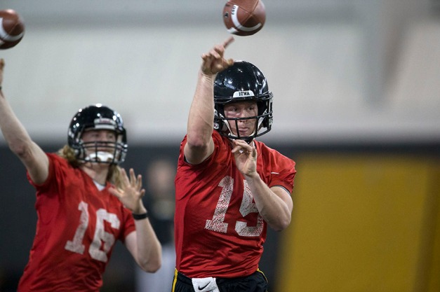 Iowa Hawkeyes quarterback Jake Rudock (15) and quarterback C.J. Beathard (16) drop back to pass during their first spring practice Wednesday, March 26, 2014 at the Hayden Fry Football Complex in Iowa City.  (Brian Ray/hawkeyesports.com)