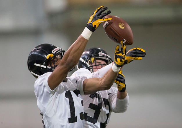 Iowa Hawkeyes defensive back Greg Mabin (13) battles for a ball with defensive back John Lowdermilk (37) as they work a drill during spring practice Friday, March 28, 2014 at the Hayden Fry Football Complex in Iowa City.  (Brian Ray/hawkeyesports.com)