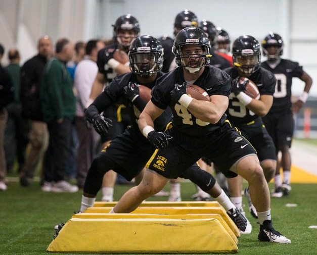 Iowa Hawkeyes fullback Mark Weisman (45) and running back Damon Bullock (5) and running back Jordan Canzeri (33) work a drill during spring practice Friday, March 28, 2014 at the Hayden Fry Football Complex in Iowa City.  (Brian Ray/hawkeyesports.com)