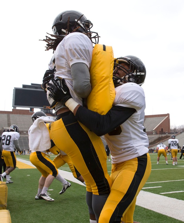 Iowa Hawkeyes defensive back Solomon Warfield (32) and defensive back Greg Mabin (13) work a drill during spring practice Saturday, March 29, 2014 at the Kinnick Stadium in Iowa City.  (Brian Ray/hawkeyesports.com)